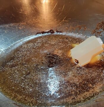 melted butter and chocolate in mixing bowl with rubber spatula, separated