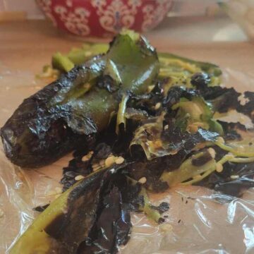 close up of roasted green chili, peels partially removed