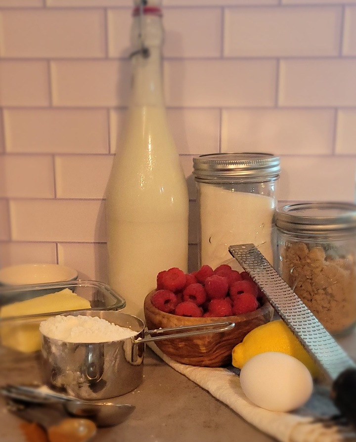 raspberry buckle ingredients; flour, butter, baking powder, buttermilk, raspberries, sugar, brown sugar, lemon, egg