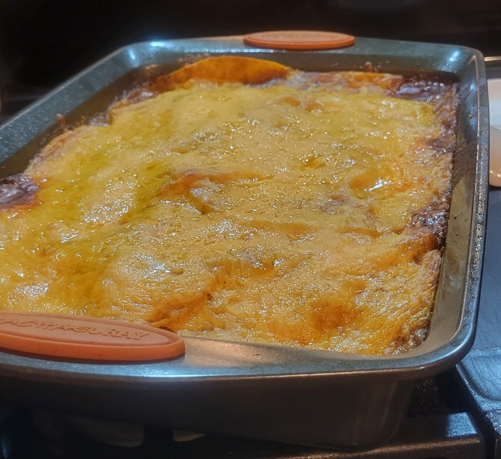 finished chicken enchilada casserole in pan