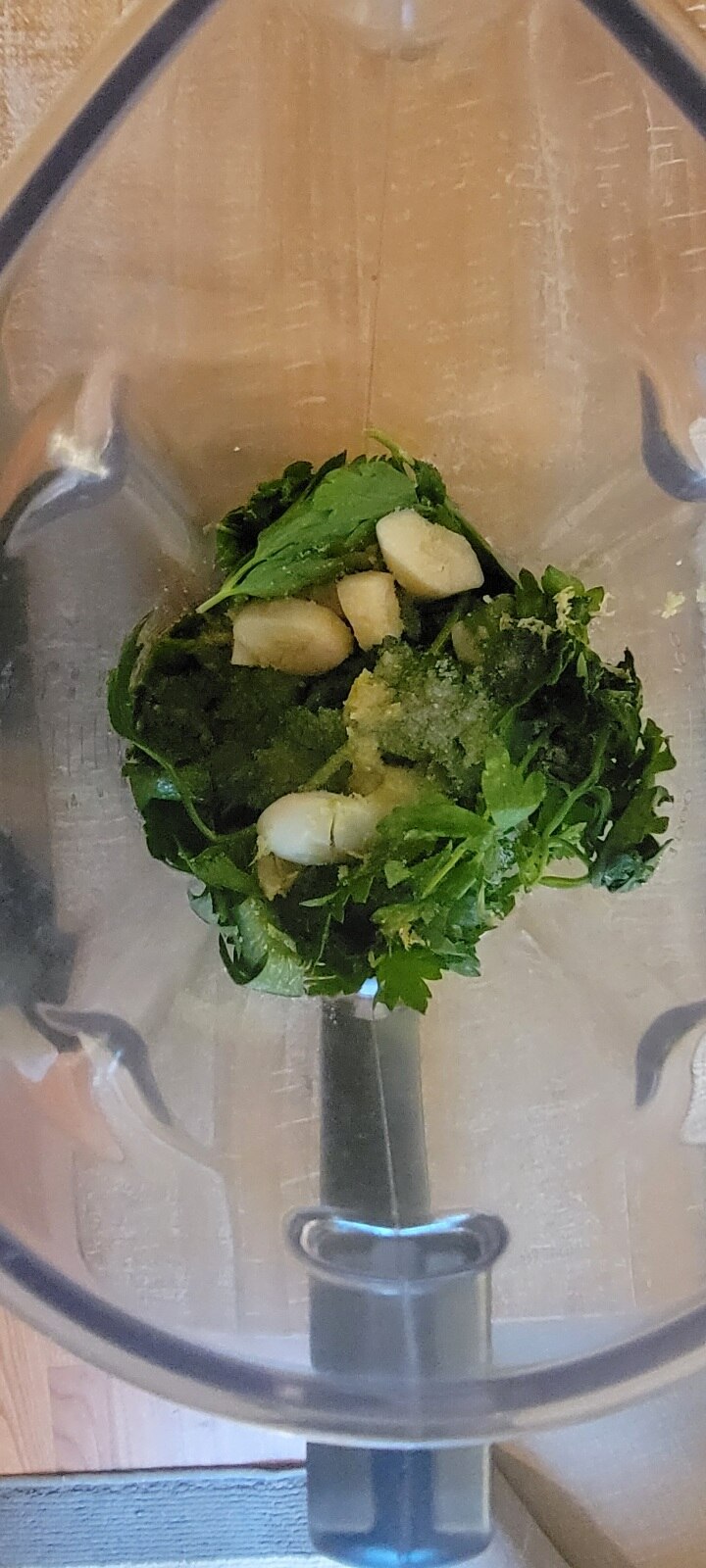 chimichurri ingredients in blender cup, shown from above