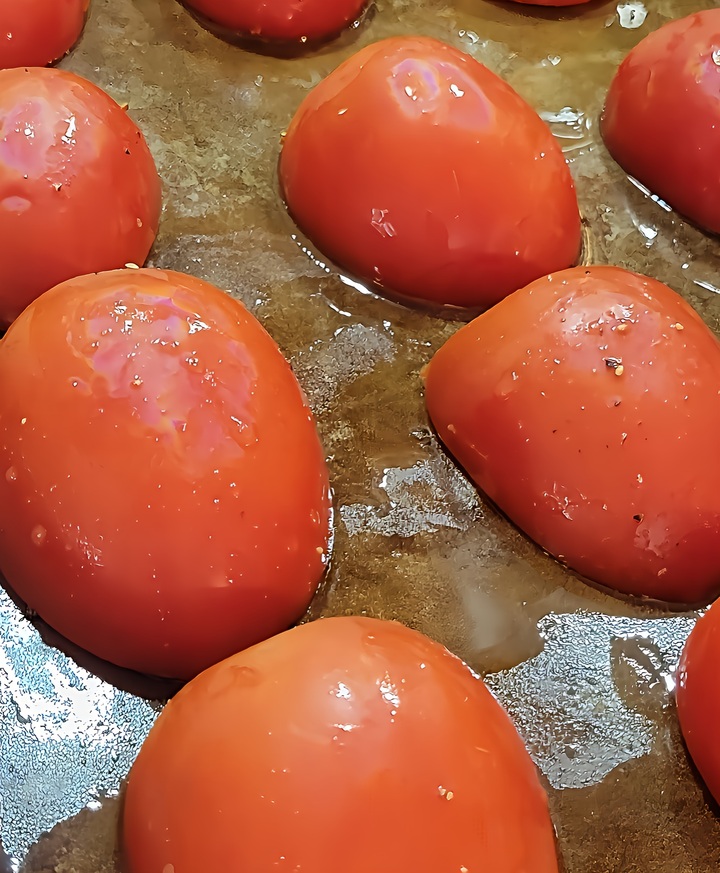 tomato halves shown on pan, ready to go in oven