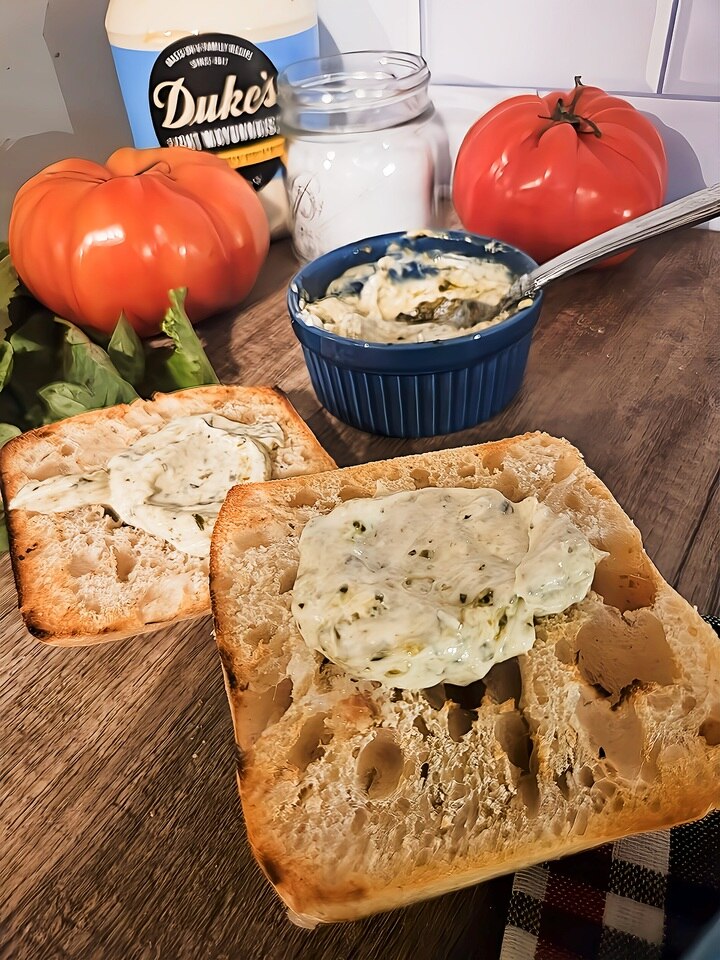 toasted ciabatta buns, open faced. smeared with pesto mayo.