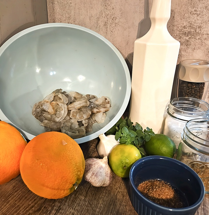 ingredients for mojo shrimp; shrimp, oregano, olive oil, salt, sugar, black pepper, cumin, limes, garlic, oranges